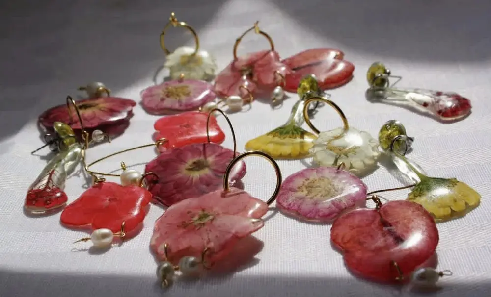 Collection of resin earrings with red and pink petals