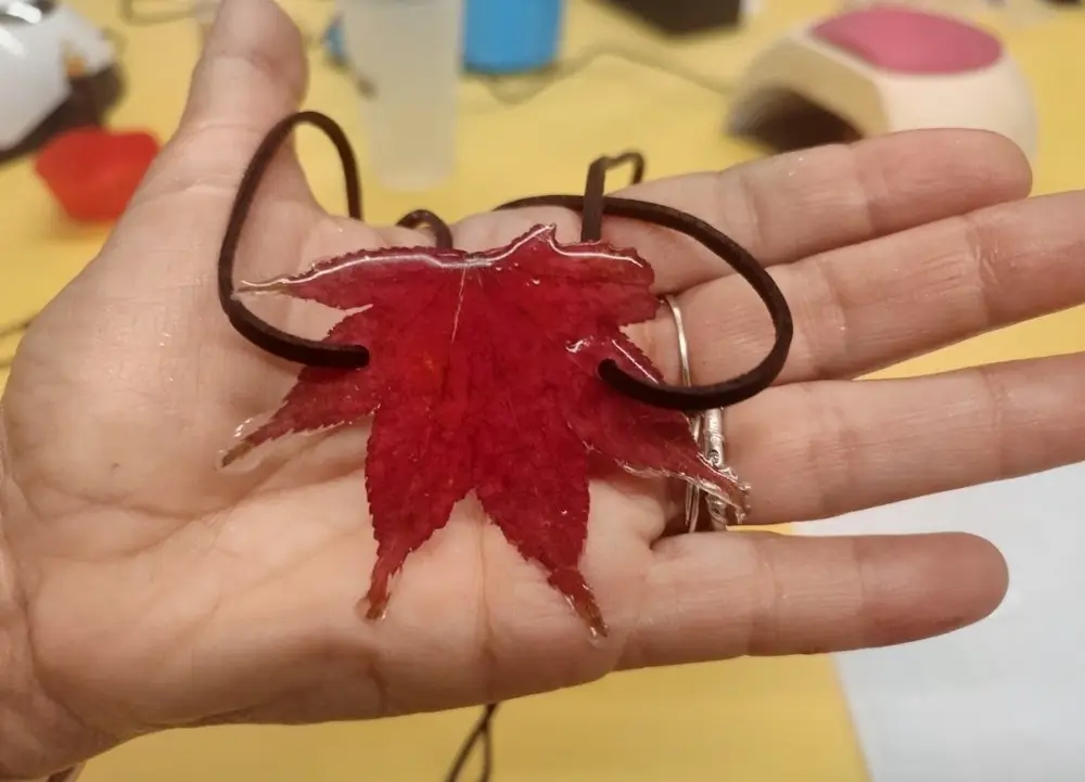 Resin pendant with a red leaf made at the workshop